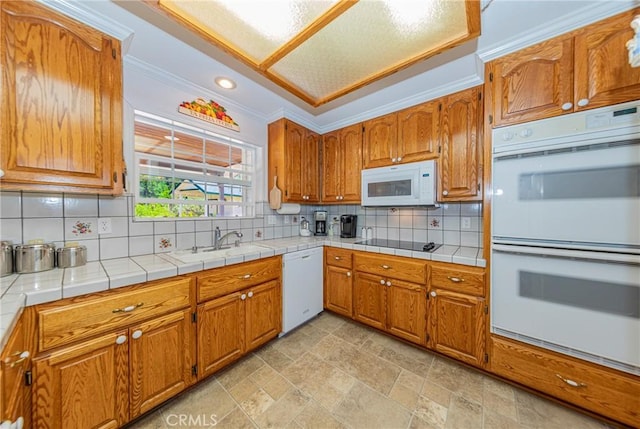 53235 Finegold Creek Ct, North Fork, CA 93643 - kitchen featuring white appliances, tasteful backsplash, brown cabinets, ornamental molding, and recessed lighting