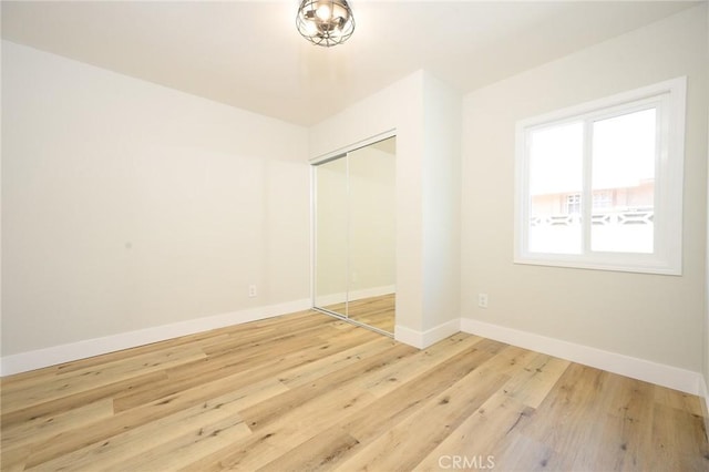 903 E 7th St, Pomona, CA 91766 - unfurnished bedroom with a closet and wood finished floors