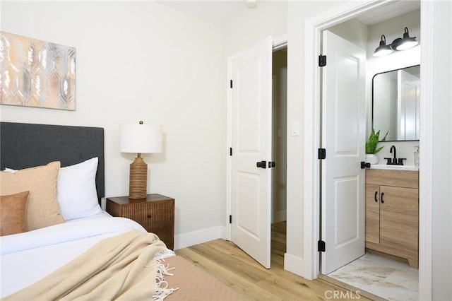 903 E 7th St, Pomona, CA 91766 - bedroom featuring light wood-style flooring and a sink