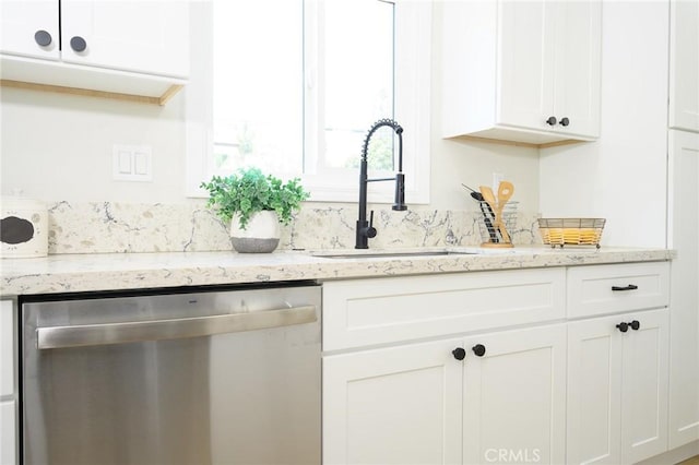 903 E 7th St, Pomona, CA 91766 - kitchen with stainless steel dishwasher, white cabinetry, and light stone countertops
