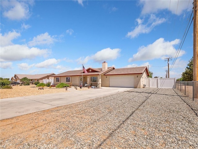 21756 Tussing Ranch Rd, Apple Valley, CA 92308 - ranch-style home with concrete driveway, a garage, stucco siding, and a chimney