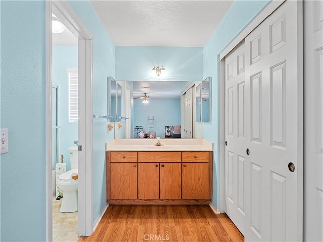 21756 Tussing Ranch Rd, Apple Valley, CA 92308 - full bathroom featuring vanity, wood finished floors, and a ceiling fan