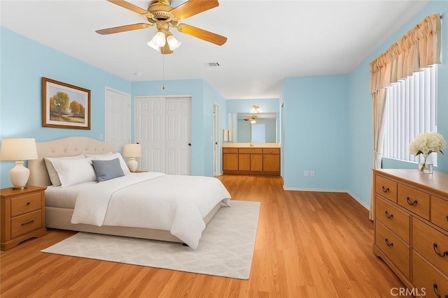 21756 Tussing Ranch Rd, Apple Valley, CA 92308 - bedroom featuring light wood-style flooring, connected bathroom, and a ceiling fan