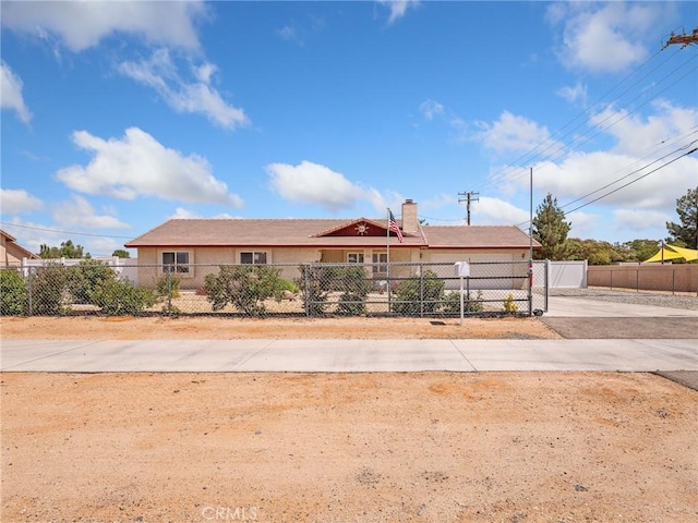 21756 Tussing Ranch Rd, Apple Valley, CA 92308 - ranch-style home with a fenced front yard, driveway, and a chimney