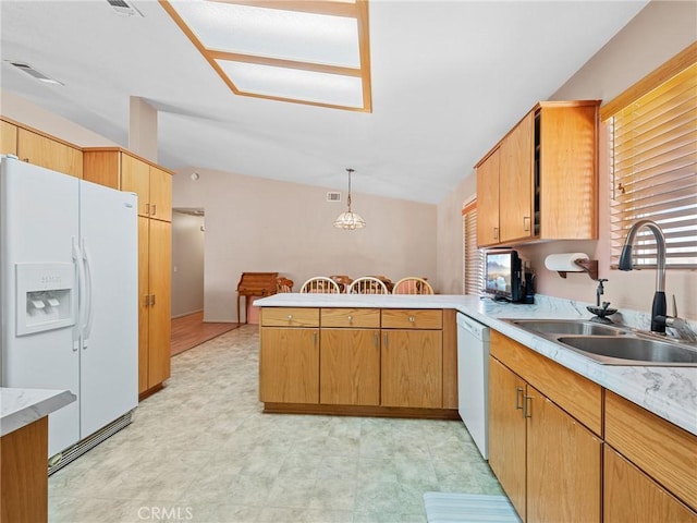 21756 Tussing Ranch Rd, Apple Valley, CA 92308 - kitchen featuring white appliances, a peninsula, light countertops, decorative light fixtures, and vaulted ceiling
