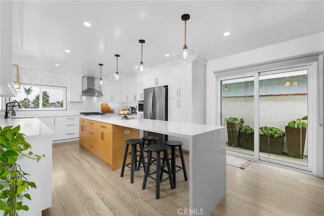 6242 E Pageantry St, Long Beach, CA 90808 - kitchen with wall chimney range hood, appliances with stainless steel finishes, plenty of natural light, tasteful backsplash, and recessed lighting