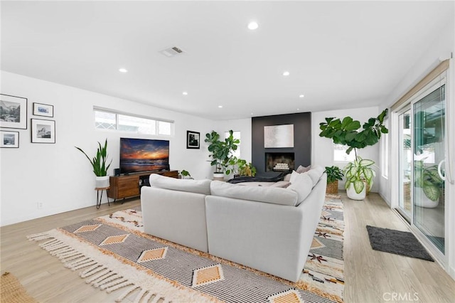 6242 E Pageantry St, Long Beach, CA 90808 - living area with healthy amount of natural light, wood finished floors, recessed lighting, and a large fireplace