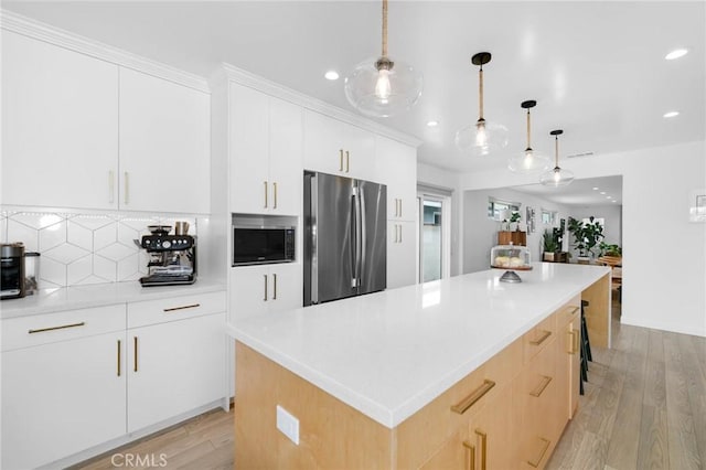 6242 E Pageantry St, Long Beach, CA 90808 - kitchen with stainless steel appliances, light wood finished floors, a kitchen island, backsplash, and recessed lighting