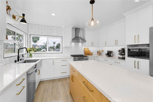 6242 E Pageantry St, Long Beach, CA 90808 - kitchen featuring wall chimney range hood, stainless steel appliances, tasteful backsplash, pendant lighting, and recessed lighting