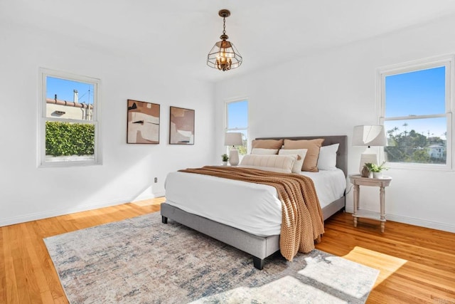 5038 Hastings Rd, San Diego, CA 92116 - bedroom featuring wood finished floors and a chandelier