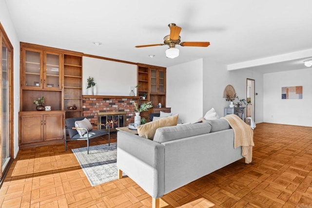 5038 Hastings Rd, San Diego, CA 92116 - living area with a brick fireplace, a ceiling fan, and built in shelves