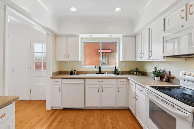 5038 Hastings Rd, San Diego, CA 92116 - kitchen with white appliances, light countertops, white cabinets, light wood-style floors, and recessed lighting
