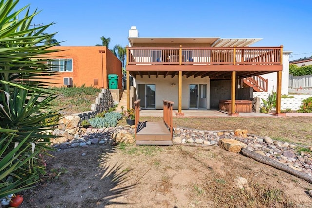 5038 Hastings Rd, San Diego, CA 92116 - rear view of house with a hot tub, a deck, stairway, stucco siding, and a chimney