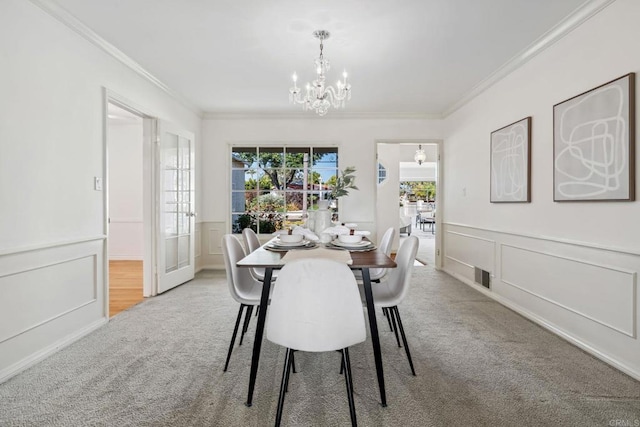 5038 Hastings Rd, San Diego, CA 92116 - carpeted dining area featuring ornamental molding, a chandelier, a decorative wall, and wainscoting