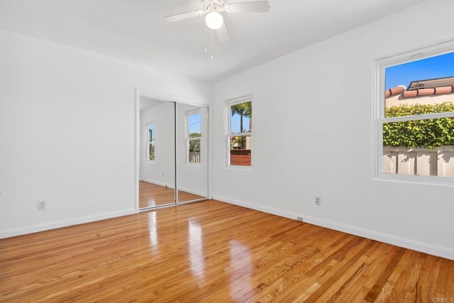 5038 Hastings Rd, San Diego, CA 92116 - unfurnished bedroom with multiple windows, light wood-style flooring, and a ceiling fan