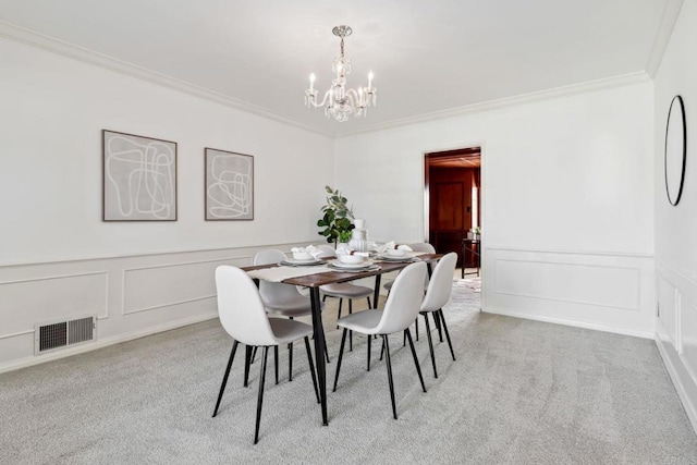 5038 Hastings Rd, San Diego, CA 92116 - carpeted dining space with a decorative wall, a chandelier, crown molding, and a wainscoted wall