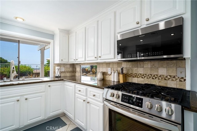 21811 Calatrava, Mission Viejo, CA 92692 - kitchen featuring appliances with stainless steel finishes, white cabinetry, dark stone countertops, tasteful backsplash, and ornamental molding