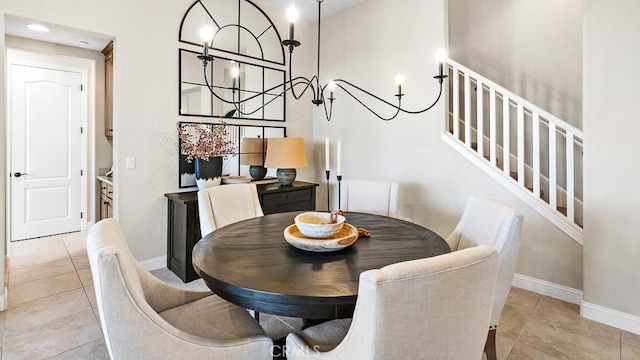 1849 Eucalyptus Rd, Nipomo, CA 93444 - tiled dining room with a chandelier, stairway, and a towering ceiling