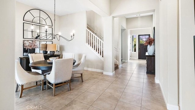1849 Eucalyptus Rd, Nipomo, CA 93444 - dining room with stairs, a chandelier, a high ceiling, and light tile patterned floors