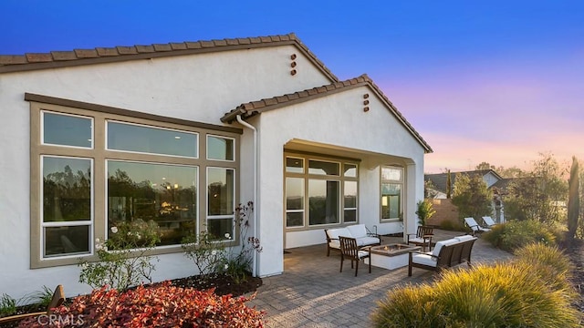 1849 Eucalyptus Rd, Nipomo, CA 93444 - rear view of house with a patio area, stucco siding, and an outdoor living space with a fire pit