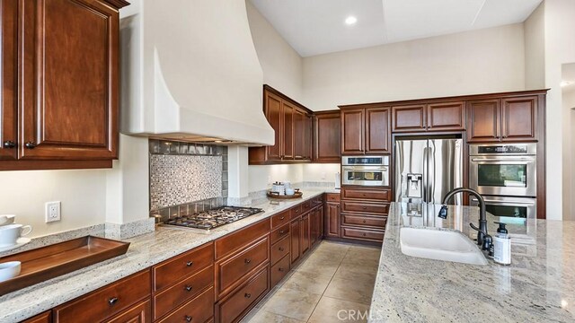 1849 Eucalyptus Rd, Nipomo, CA 93444 - kitchen featuring custom range hood, appliances with stainless steel finishes, light stone countertops, and light tile patterned floors