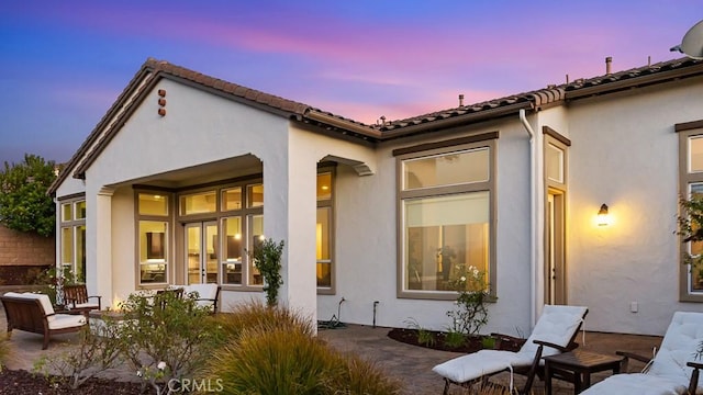 1849 Eucalyptus Rd, Nipomo, CA 93444 - back of house at dusk with stucco siding and a patio