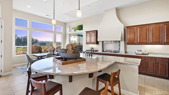 1849 Eucalyptus Rd, Nipomo, CA 93444 - kitchen with light tile patterned floors, a high ceiling, stainless steel gas stovetop, light stone counters, and recessed lighting
