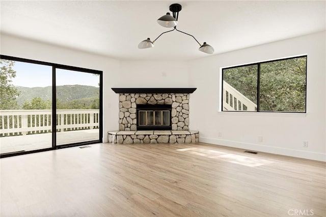 30260 Gremlin Ct, Running Springs, CA 92382 - unfurnished living room with wood finished floors and a fireplace