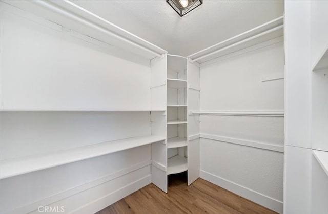 30260 Gremlin Ct, Running Springs, CA 92382 - walk in closet featuring wood finished floors