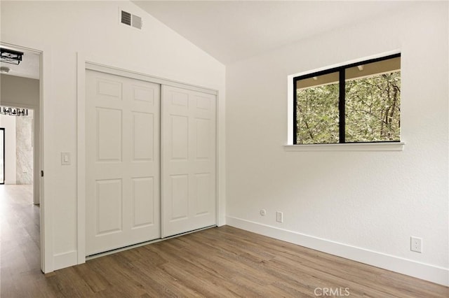 30260 Gremlin Ct, Running Springs, CA 92382 - unfurnished bedroom featuring lofted ceiling, wood finished floors, and a closet