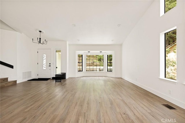30260 Gremlin Ct, Running Springs, CA 92382 - unfurnished living room featuring a chandelier and wood finished floors