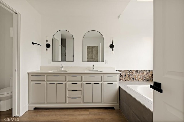 30260 Gremlin Ct, Running Springs, CA 92382 - bathroom featuring double vanity, a bath, and wood finished floors