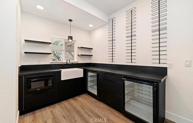 30260 Gremlin Ct, Running Springs, CA 92382 - indoor bar with wine cooler, light wood-type flooring, black microwave, and recessed lighting