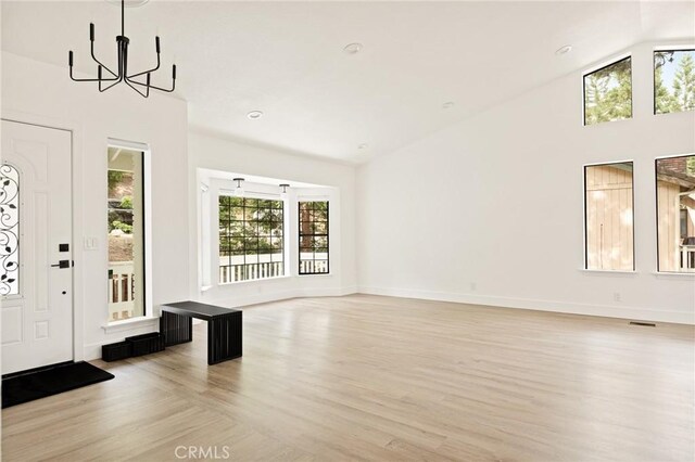 30260 Gremlin Ct, Running Springs, CA 92382 - entrance foyer featuring a chandelier, light wood-style flooring, lofted ceiling, and recessed lighting