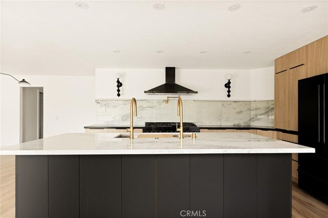 30260 Gremlin Ct, Running Springs, CA 92382 - kitchen with wall chimney range hood, freestanding refrigerator, modern cabinets, a large island, and backsplash
