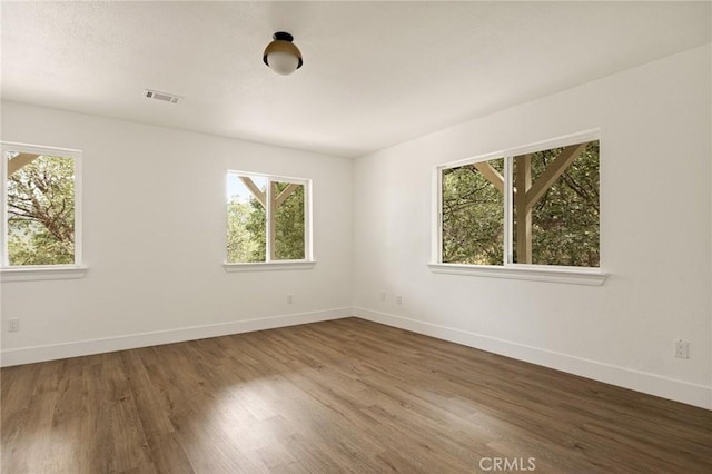 30260 Gremlin Ct, Running Springs, CA 92382 - spare room featuring healthy amount of natural light and wood finished floors