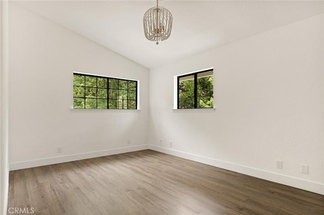 30260 Gremlin Ct, Running Springs, CA 92382 - spare room with a chandelier, lofted ceiling, and wood finished floors
