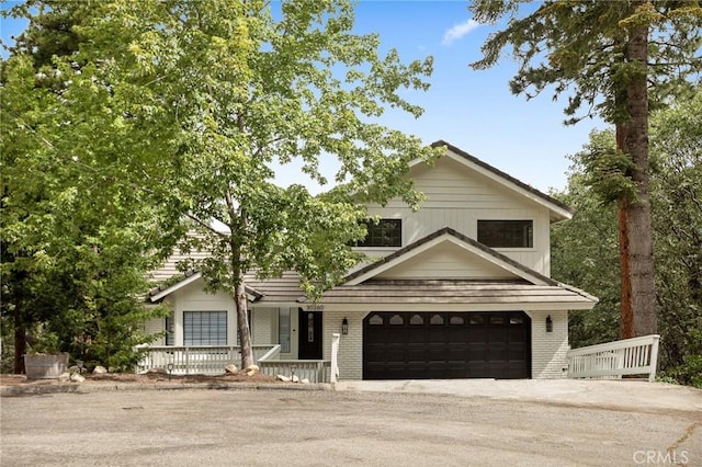 30260 Gremlin Ct, Running Springs, CA 92382 - view of front facade with covered porch, a garage, driveway, and brick siding