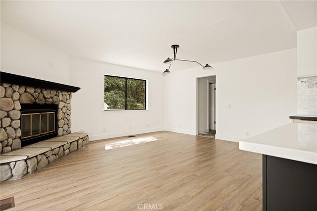 30260 Gremlin Ct, Running Springs, CA 92382 - unfurnished living room featuring light wood-style flooring and a fireplace
