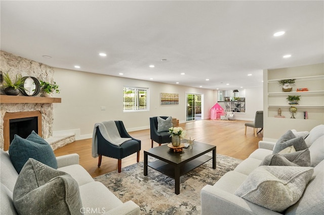 1917 N Quince Way, Upland, CA 91784 - living area featuring recessed lighting, a stone fireplace, and light wood finished floors