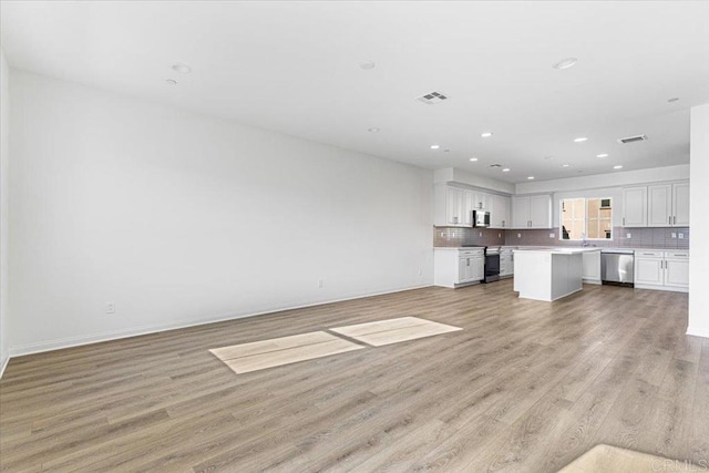 8608 Amherst St, Santee, CA 92071 - unfurnished living room with light wood-style floors and recessed lighting