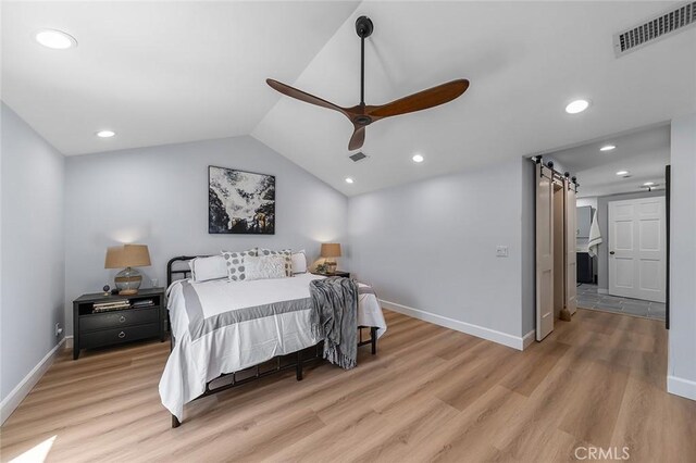 232 7th St, Seal Beach, CA 90740 - bedroom featuring a barn door, light wood-type flooring, vaulted ceiling, recessed lighting, and ceiling fan