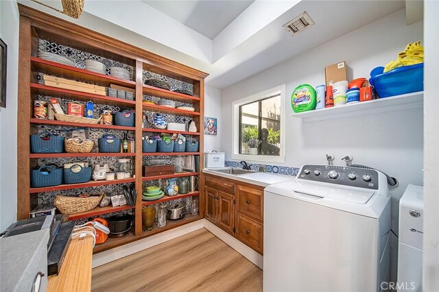 232 7th St, Seal Beach, CA 90740 - laundry room featuring cabinet space, light wood finished floors, and washing machine and clothes dryer