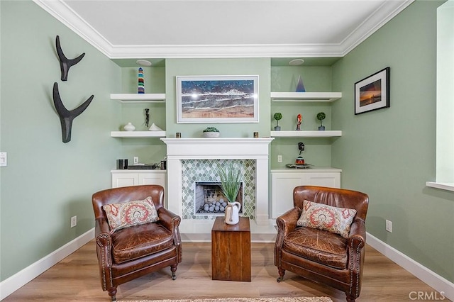 232 7th St, Seal Beach, CA 90740 - sitting room with wood finished floors, ornamental molding, a tile fireplace, and built in features
