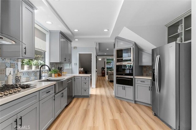 232 7th St, Seal Beach, CA 90740 - kitchen with appliances with stainless steel finishes, gray cabinets, a warming drawer, extractor fan, and light wood finished floors