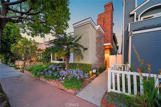 232 7th St, Seal Beach, CA 90740 - view of property exterior with a chimney and stucco siding
