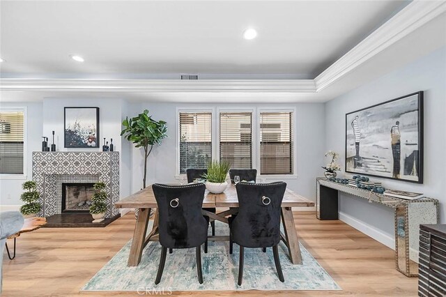 232 7th St, Seal Beach, CA 90740 - dining area featuring recessed lighting, ornamental molding, light wood-type flooring, a fireplace, and plenty of natural light