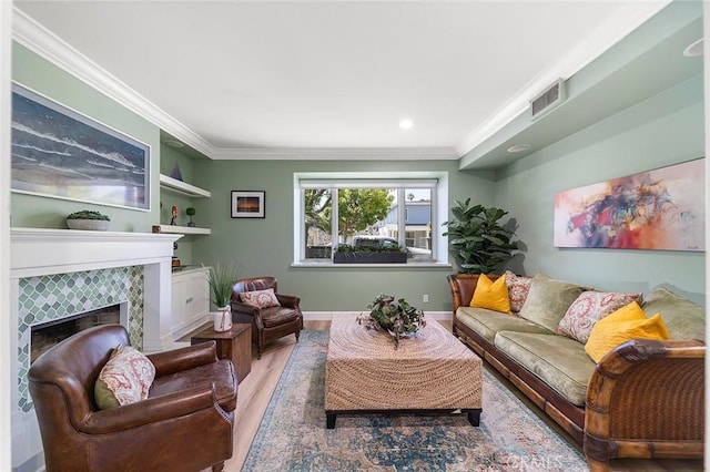 232 7th St, Seal Beach, CA 90740 - living room with wood finished floors, crown molding, a tiled fireplace, and recessed lighting