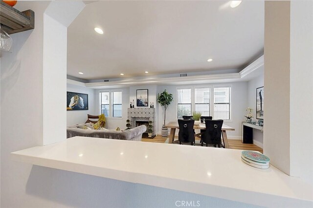 232 7th St, Seal Beach, CA 90740 - kitchen with a fireplace, an office area, a raised ceiling, wood finished floors, and recessed lighting