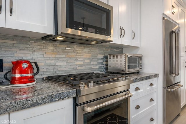 4073 Aladdin Dr, Huntington Beach, CA 92649 - kitchen with stainless steel appliances, white cabinetry, decorative backsplash, and dark countertops